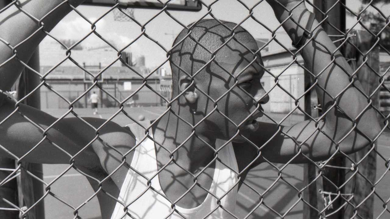 a man behind a fence